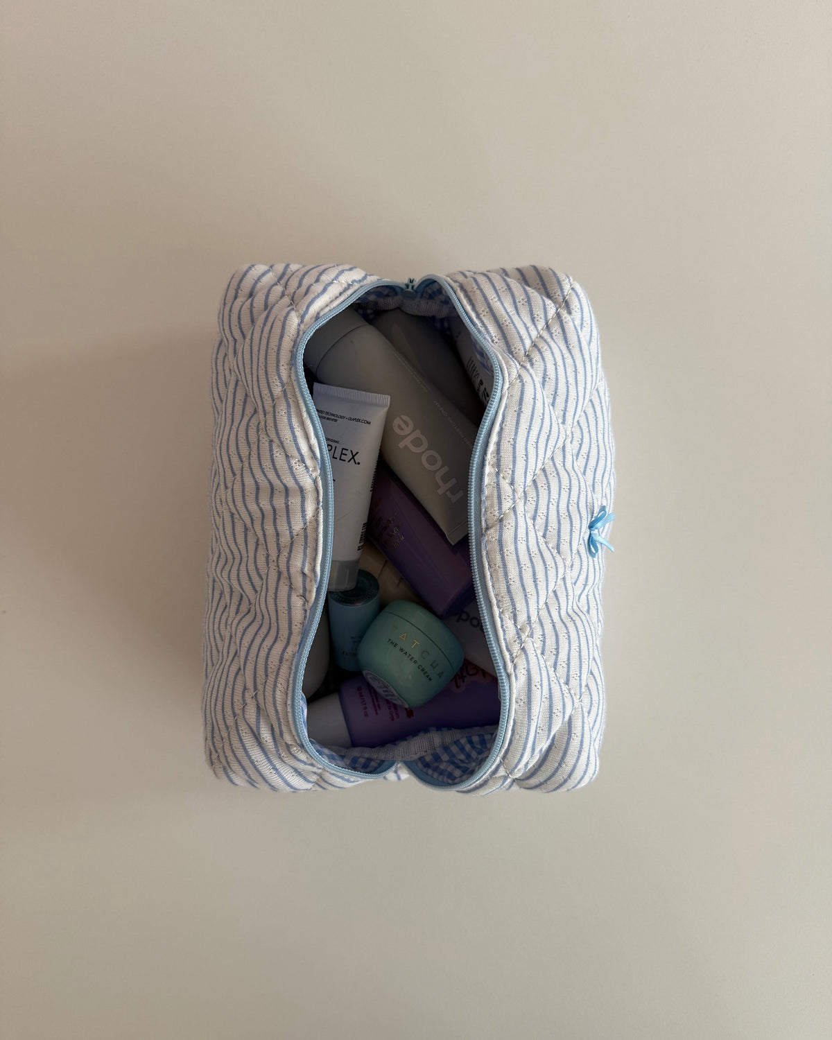 Trousse de maquillage bleu ligné