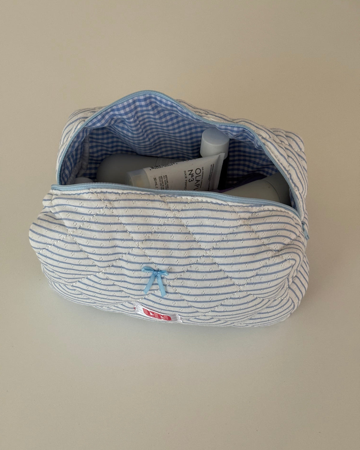 Trousse de maquillage bleu ligné