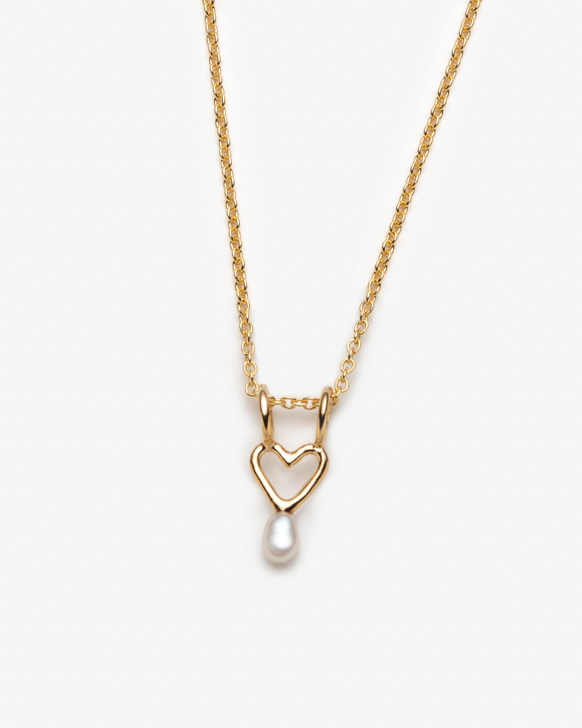 Necklace with heart charm and small white pearl